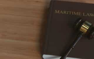 Maritime law book with court gavel on top